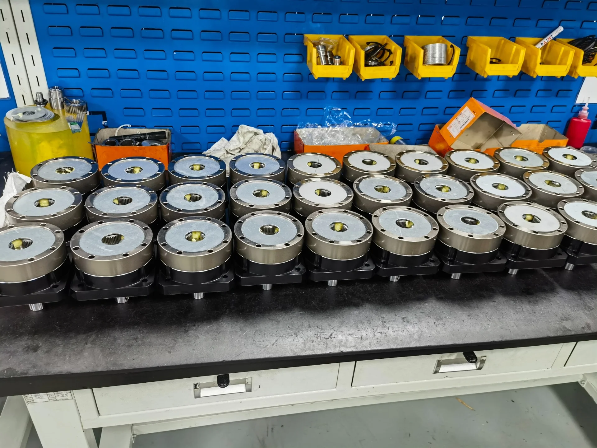Rows of gearbox units on an assembly workbench