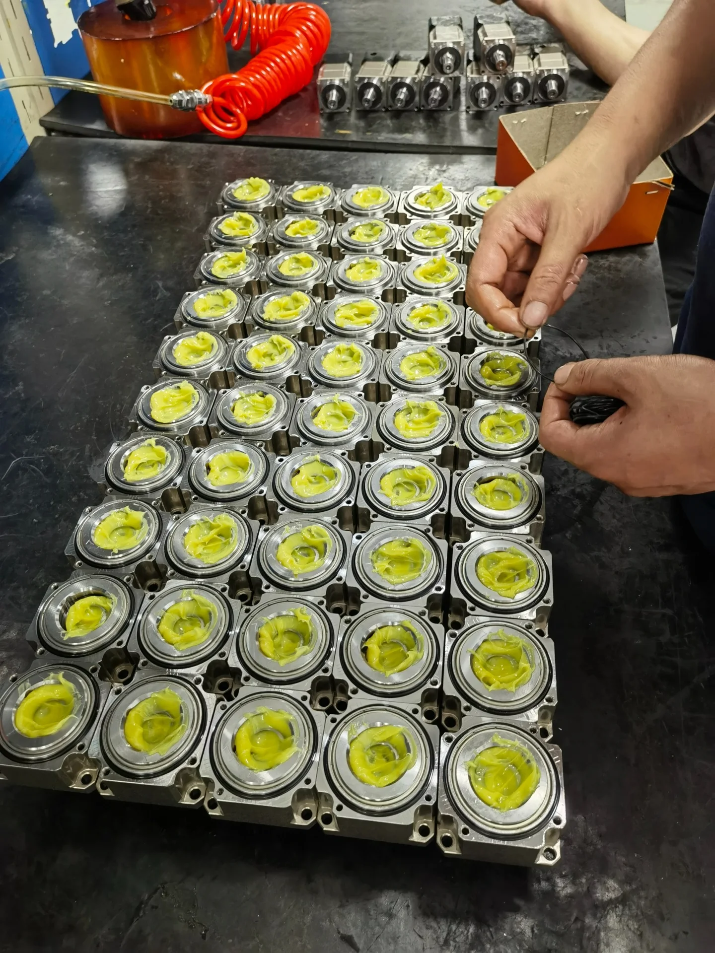 An operator assembling gearbox components at a workbench